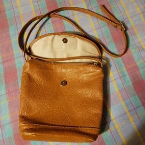 Embossed leather crossbody zip and snap purse.